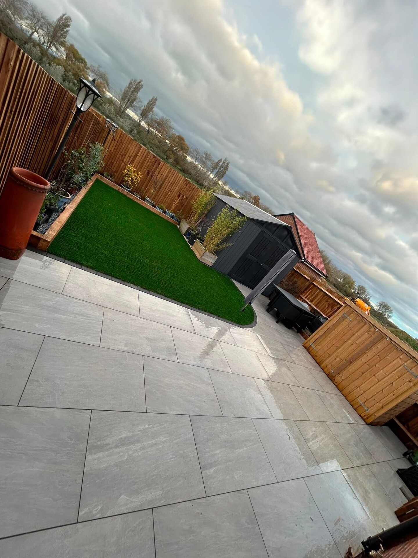 Porcelain patio combined with artificial grass and a BBQ entertaining area.