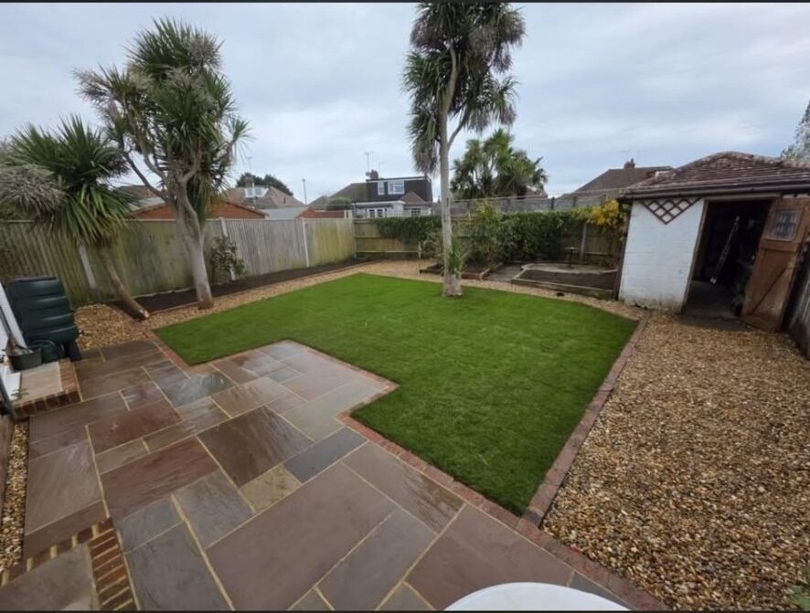 Indian sandstone patio and rear lawn redesigned as part of a full garden transformation.