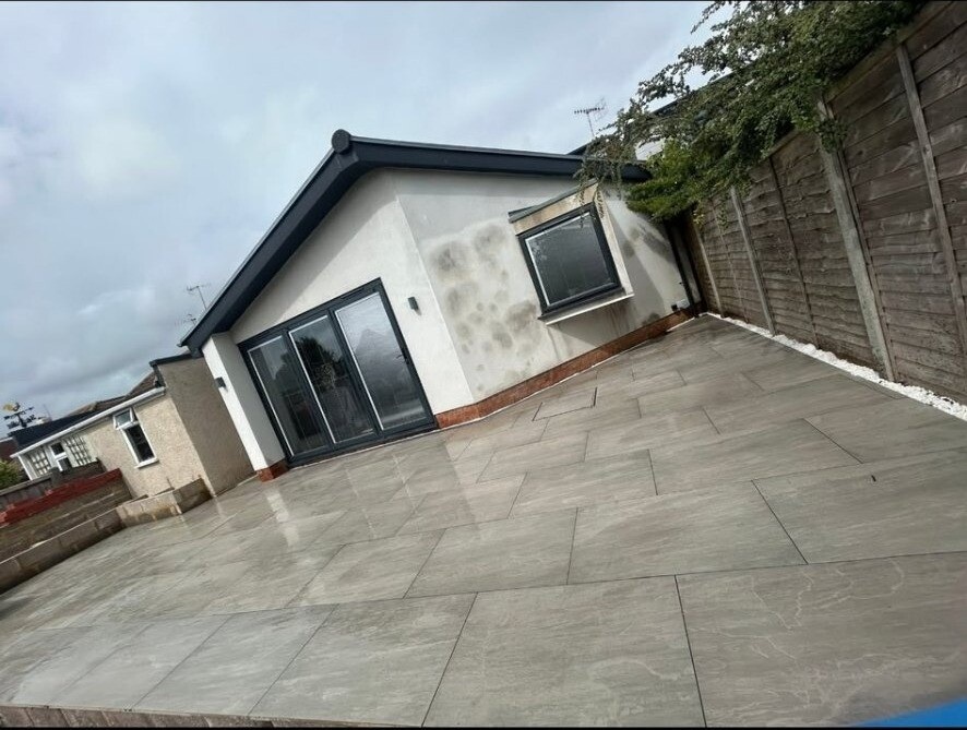 Porcelain pathway alongside a driveway elevation at a West Sussex home.