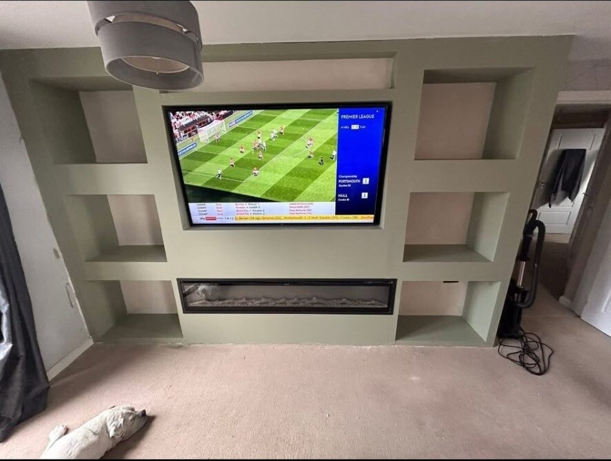 Bespoke media wall with integrated TV, electric fire and built-in shelving.