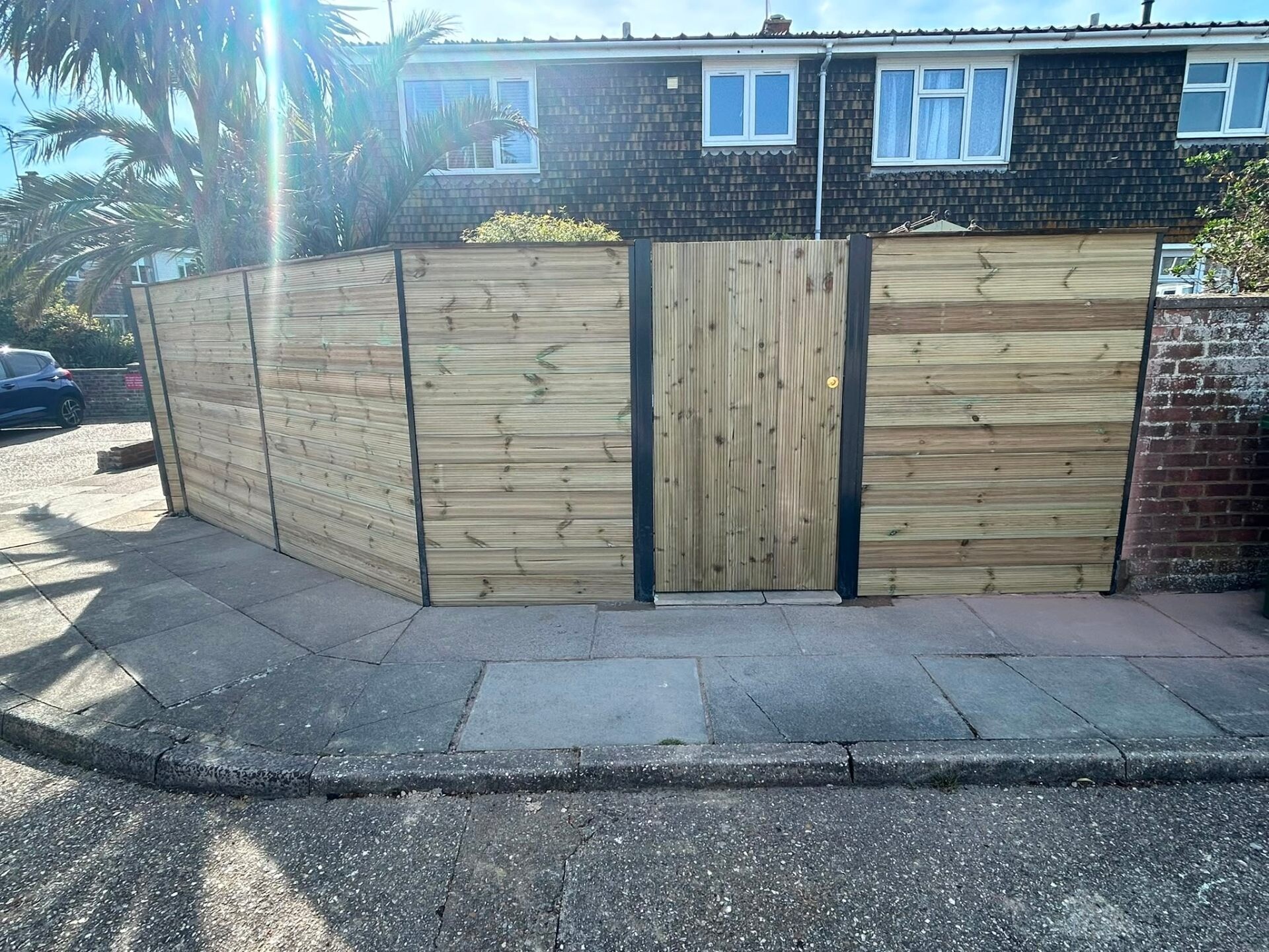 New closeboard fencing run installed alongside a paved driveway in West Sussex.